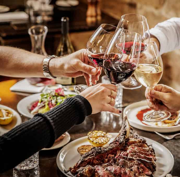 Kingsleys: Happy group celebrating with wine and food